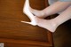 A woman's feet in high heels on a wooden table.