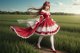 A woman in a red and white dress standing in a field.