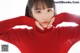 a woman in a red turtle neck sweater posing for a picture